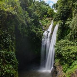 Feeling the Fresh Waterfall in the Middle of a Forest